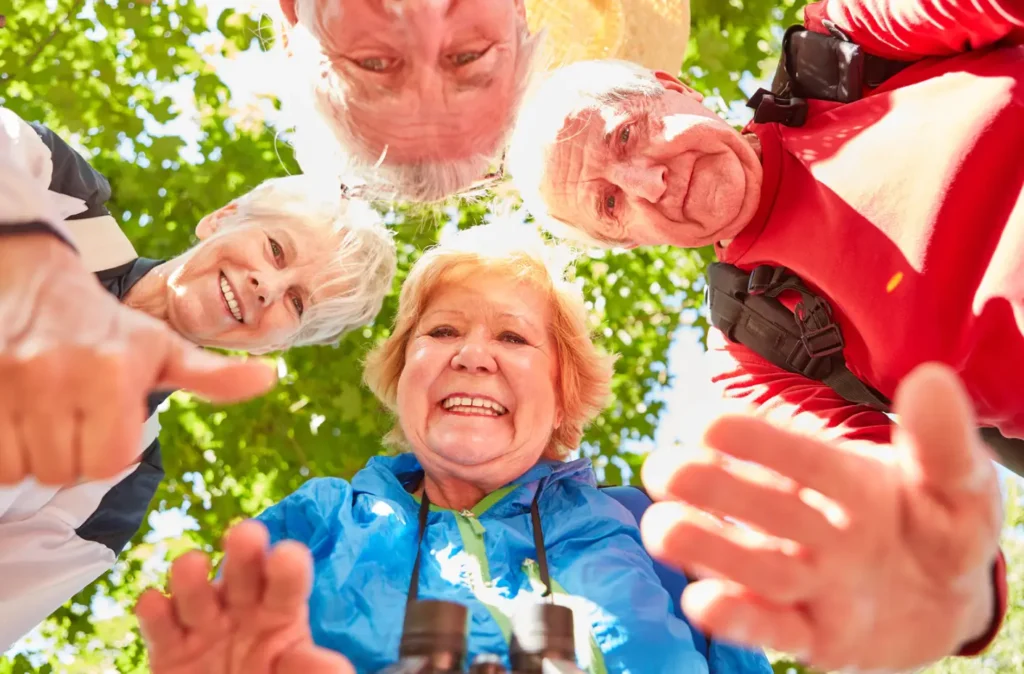 a group of seniors capturing themselves outside as an example of an activities of daily living