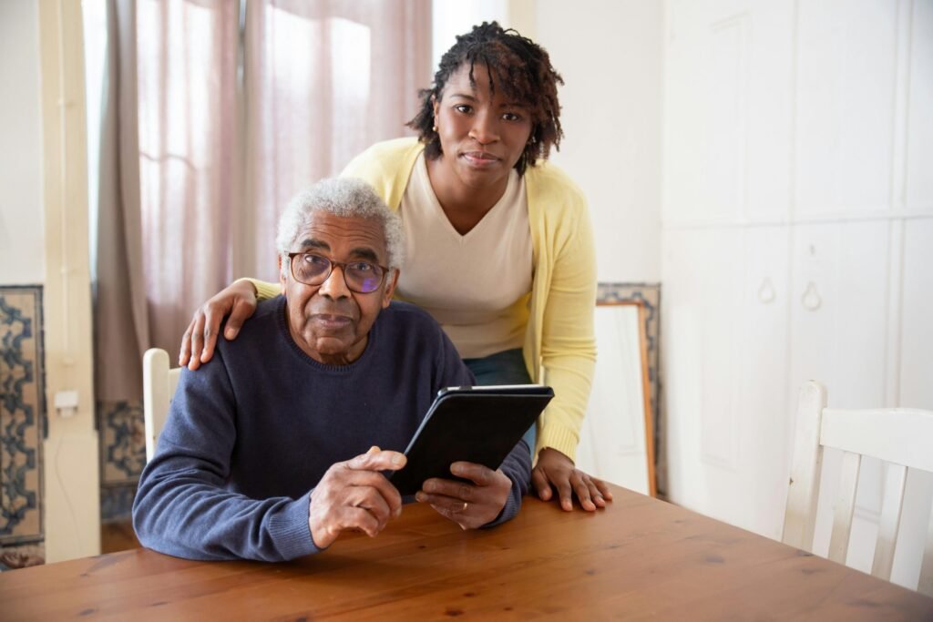 a young black american teaching her father senior safety at home through an app