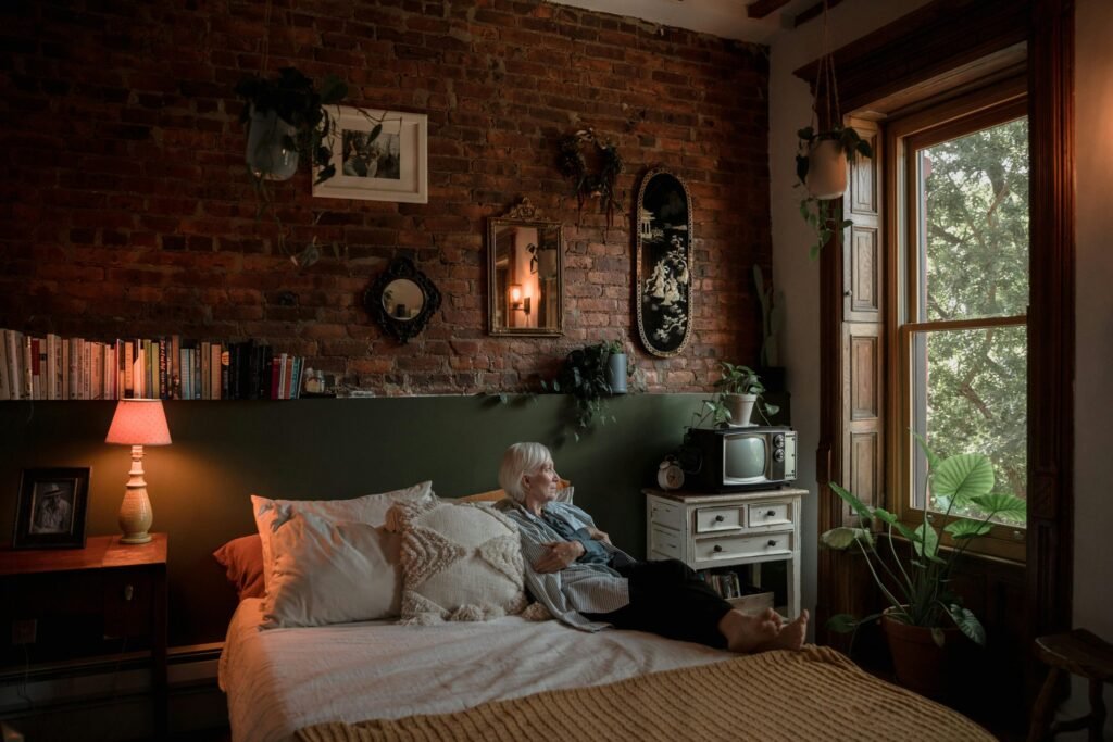 older woman lying in the bed as a senior living alone