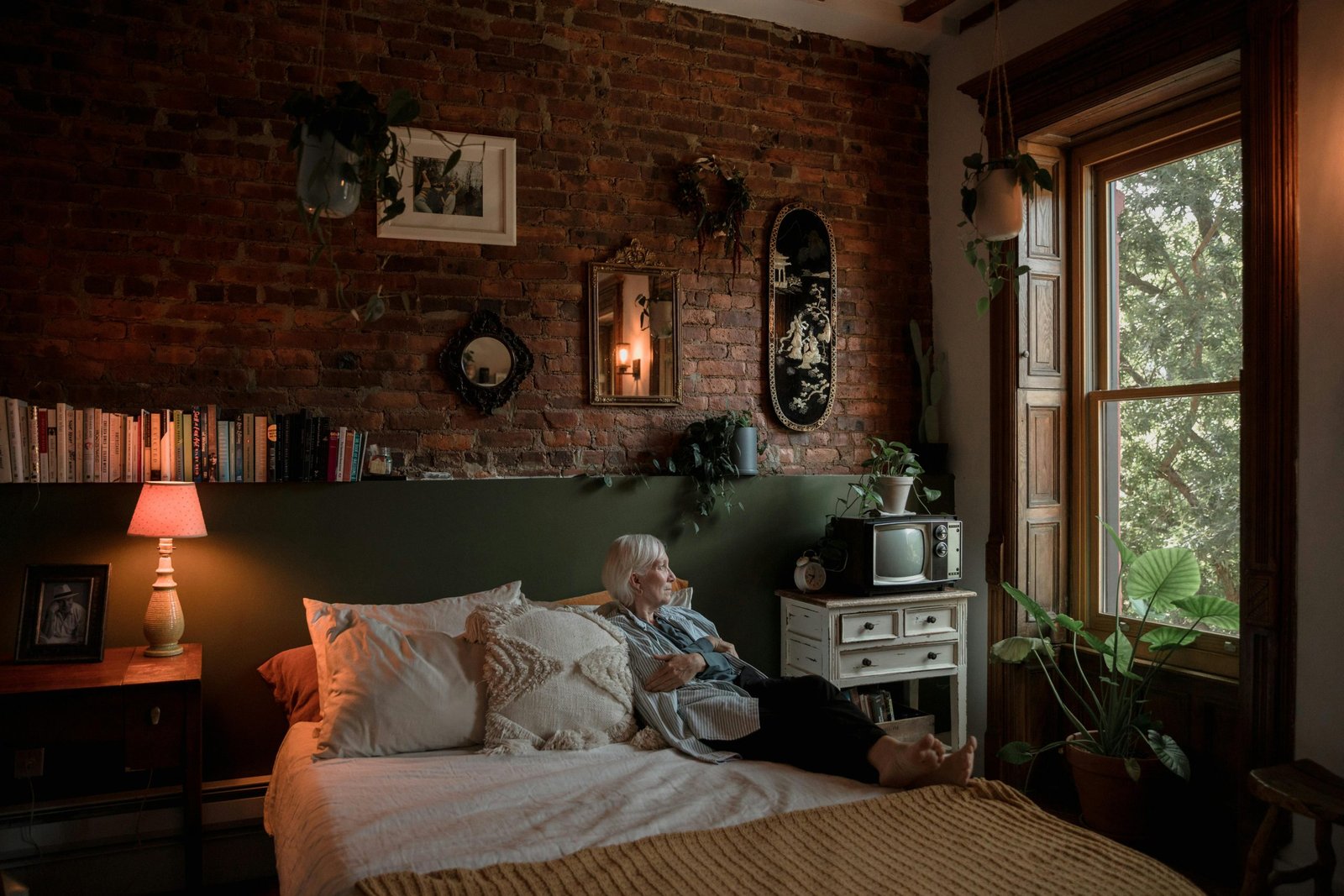 older woman lying in the bed as a senior living alone